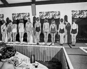 Women facing away on stage of Beauty Pageant