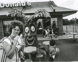 Woman with drink in front of McDonald's play park